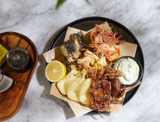 A plate of seafood and lemon on a table

Description automatically generated