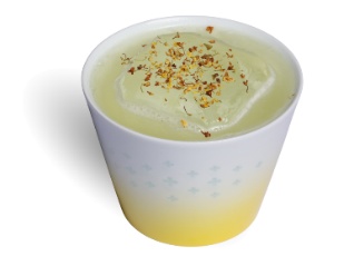 A cup of liquid with a sprinkle of flakes Description automatically generated