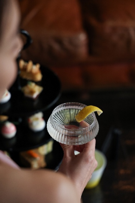 A person holding a drink Description automatically generated